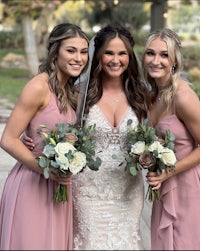 three bridesmaids posing with their bouquets